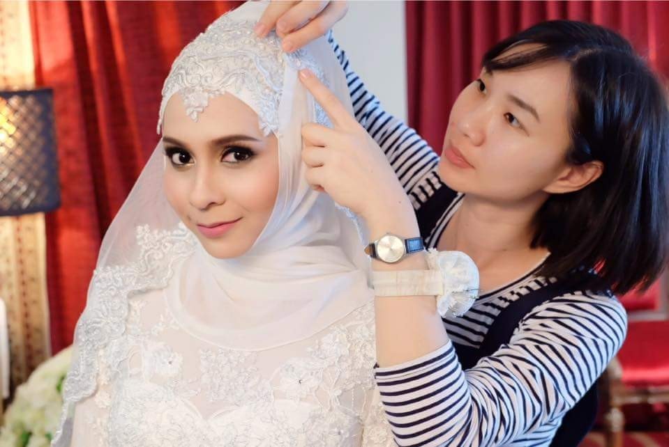 ARAYA team styling the bride's hijab before the Nikah ceremony