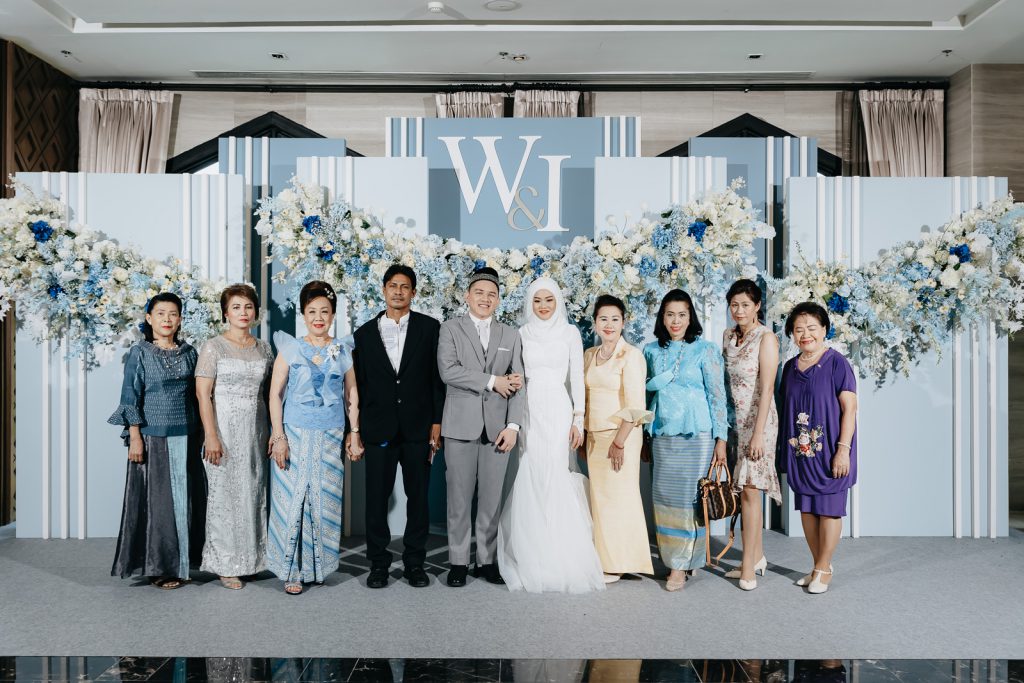 Blue-and-white backdrop with the couple's names